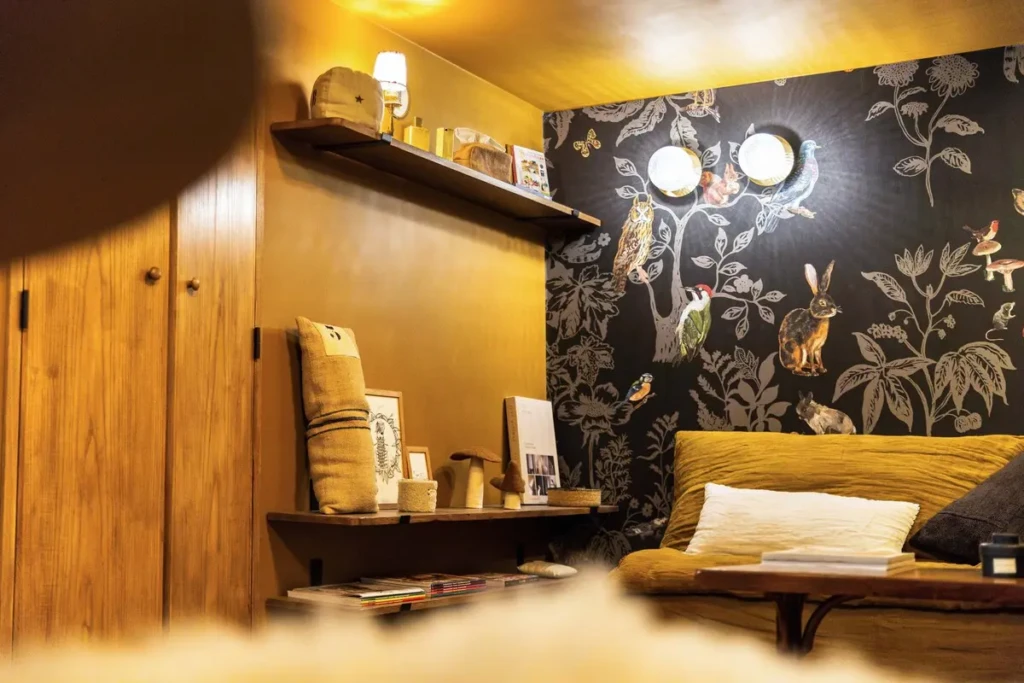 Intérieur cosy du studio Chez Louise avec décoration murale colorée et espace salon.